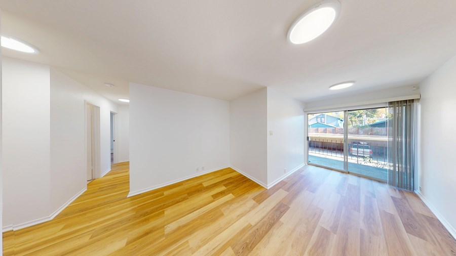 A room with wooden floors and white walls.